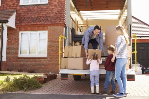 Professional movers loading furniture for urgent relocation