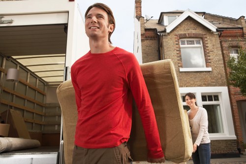 Furniture and boxes being loaded into a moving truck in Wood Green