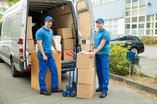 Professional movers handling furniture during a Woodgreen flat removal
