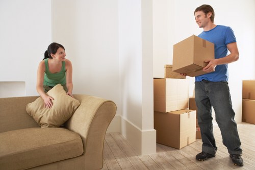 Removals team handling stairs and furniture in a Wood Green flat